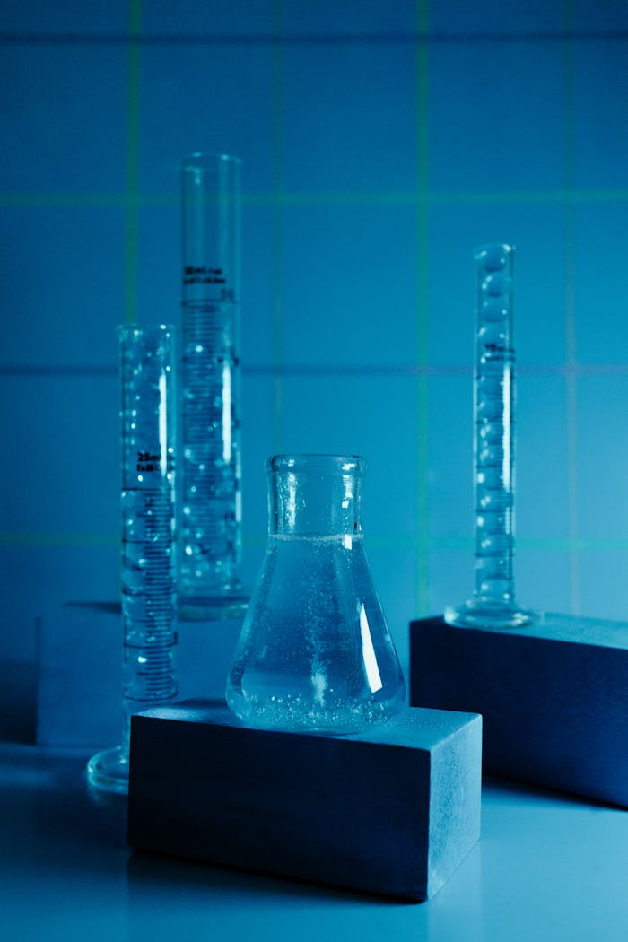 Chemistry lab setup featuring flasks and test tubes with a blue tone.